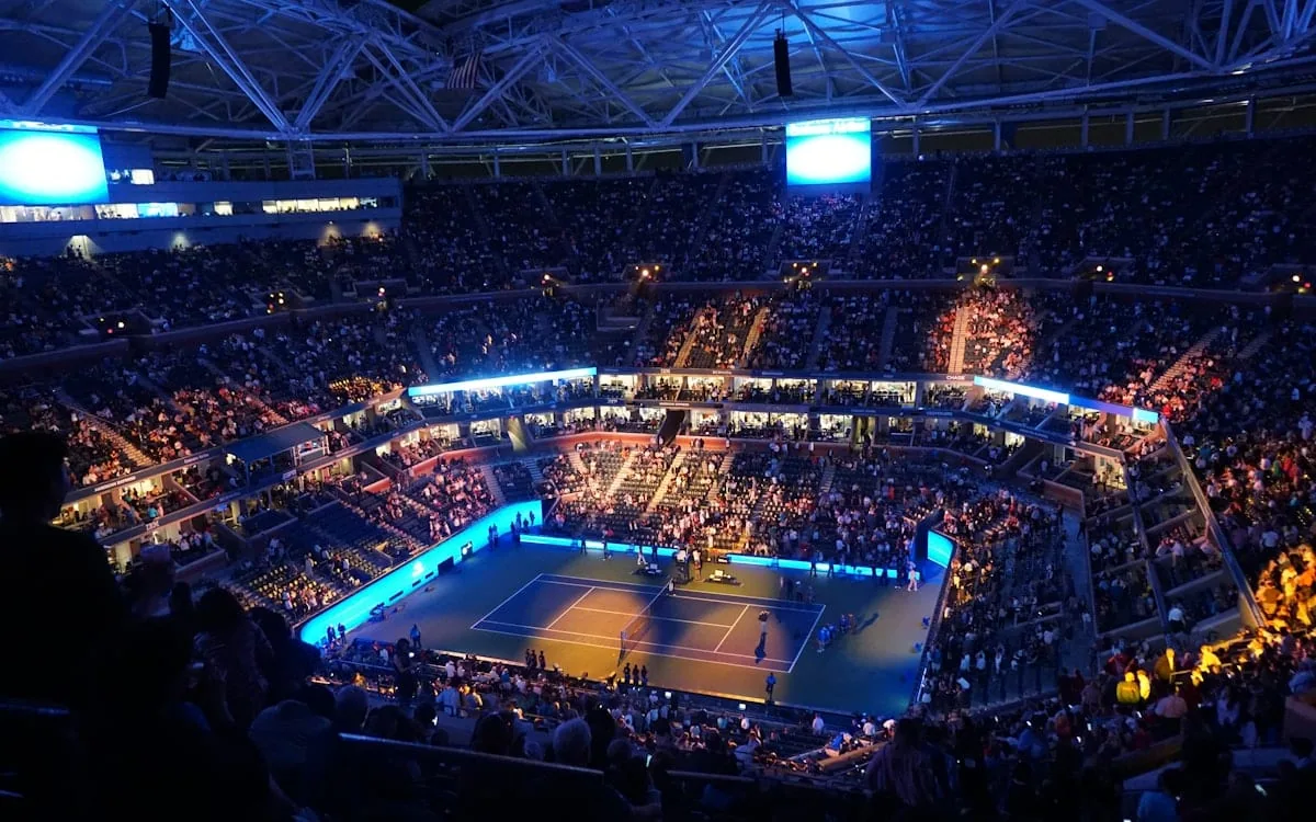 A packed tennis arena lit up for a night session, the kind of stage Gael Monfils spent twenty years filling